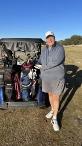 Happy golfer displaying his new red, white and blue golf bag.