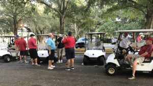 A group of golfers gather before teeing off in a shotgun start at a Florida golf course.