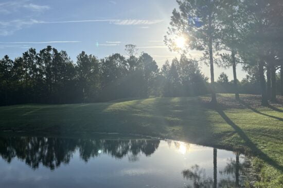 Sunrise over a lake on the second hole at Orange Lake Reserve Course in Kissimmee, Florida