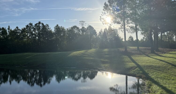 Sunrise over a lake on the second hole at Orange Lake Reserve Course in Kissimmee, Florida