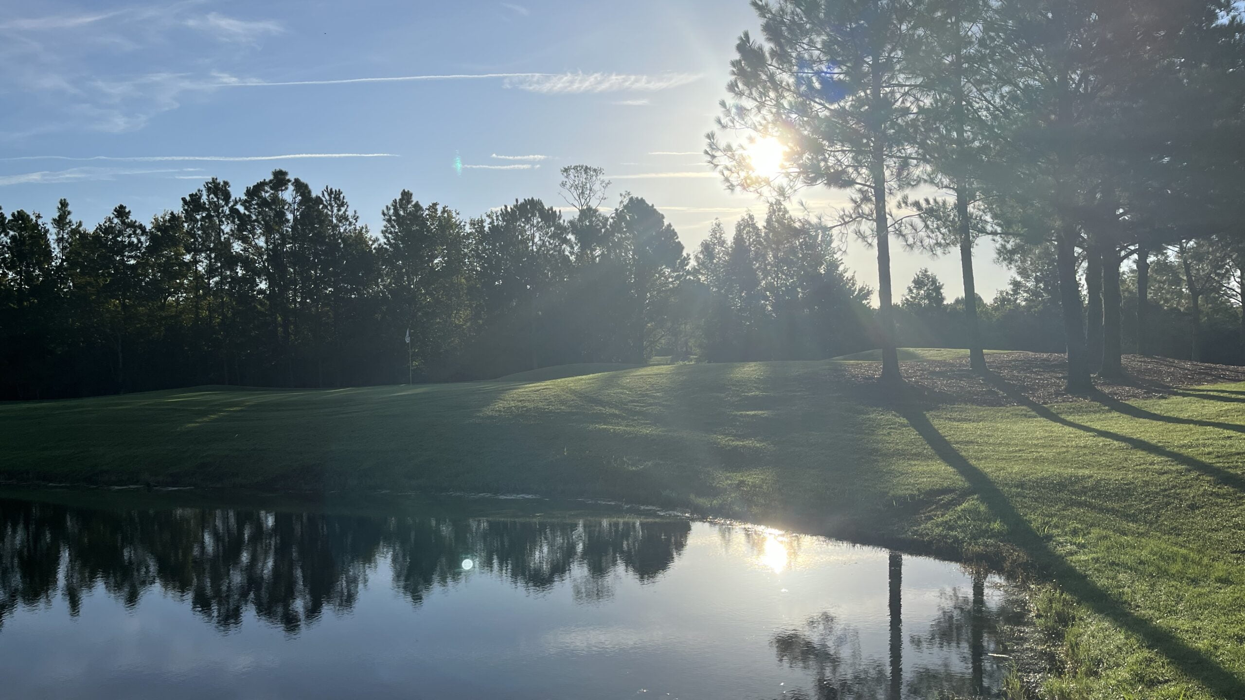 Sunrise over a lake on the second hole at Orange Lake Reserve Course in Kissimmee, Florida