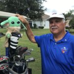 Happy golfer displaying his Grogu head cover.